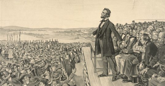 A man standing on a podium, showcasing his skills in public speaking to a captivated crowd.