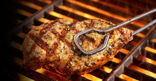Chicken breasts are grilling to perfection on the grill.