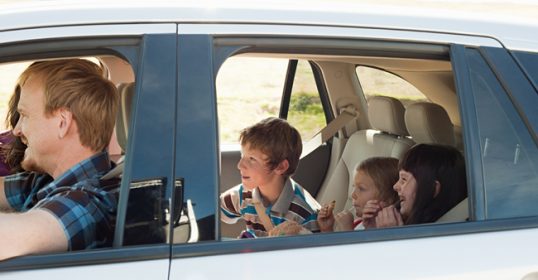 A family with kids in a car.