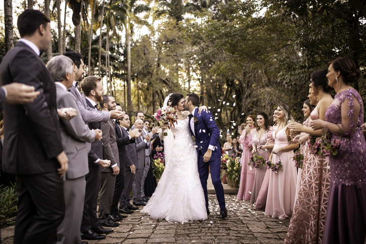 A bride and groom share a kiss at their wedding.