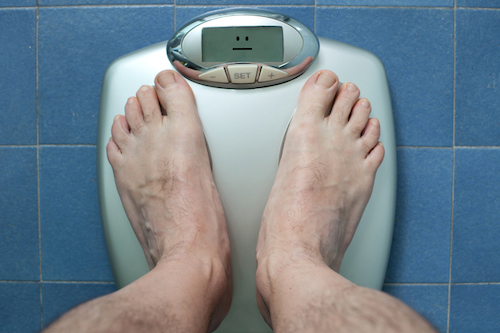 A person's weight on a scale.