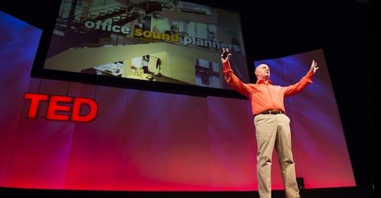 A TED Talker standing on stage at a TED event.