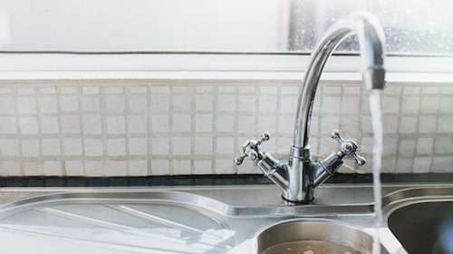 A kitchen sink with a faucet to increase water pressure at home.