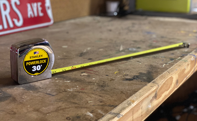 A trusty tape measure rests on the wooden table.