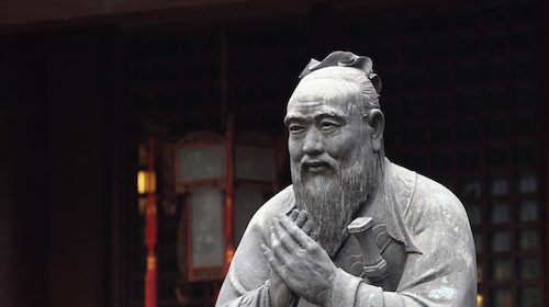 A statue of a Chinese man with a beard, resembling a Confucian gentleman.