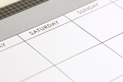 A close up image of a calendar on a desk featuring the Take Back the Weekend logo.