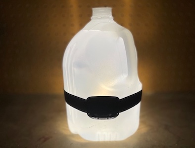 A bottle of water with a lantern attached to it, perfect for illuminating dark spaces.