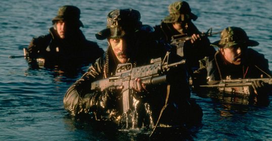 A group of Navy's Frogmen in the water with rifles.