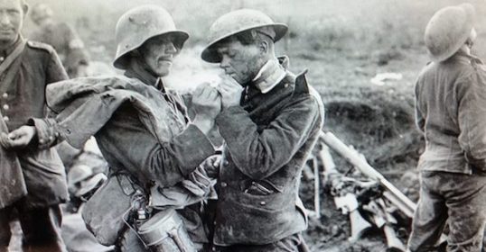 Two men in uniforms having a conversation during the Christmas Truce of WWI.