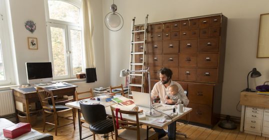 A man and woman are collaborating on a laptop in a room, aiming to create a better life.