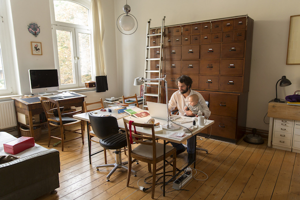 A man and woman are collaborating on a laptop in a room, aiming to create a better life.