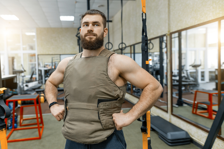 A bearded man in a gym posing for a photo.