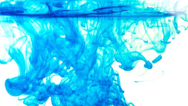 A blue liquid is poured into a glass, demonstrating the dangers of concept creep.