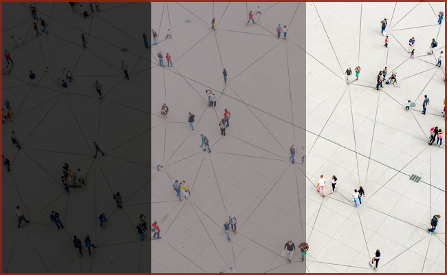 A black and white image of people walking in a square, depicting ambivalent relationships.