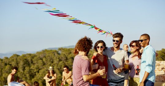 A group of people standing around a pool.
