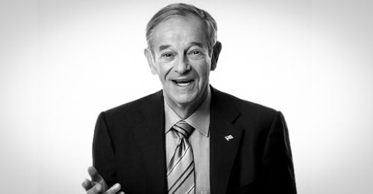 A black and white photo of a man in a suit, portraying the essence of a negotiator.
