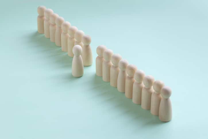 A line of well-differentiated wooden figures, becoming a leader.