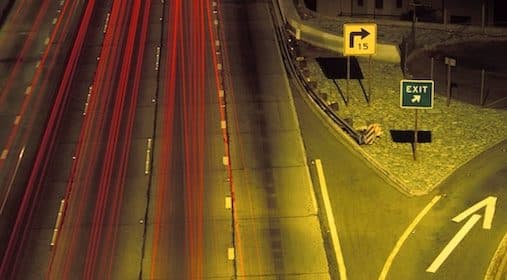 An aerial view of a busy highway at night.
