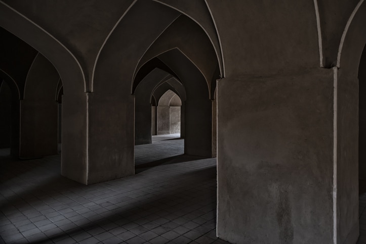 The interior of the mosque features arches and pillars.