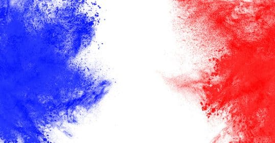 Blue and red powder explosion on a white background, symbolizing the theme of