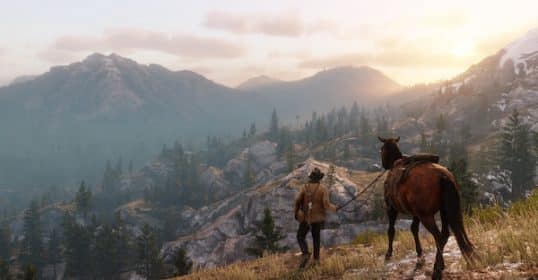 A character from Red Dead Redemption 2 stands next to a horse, overlooking a mountainous landscape at sunset.