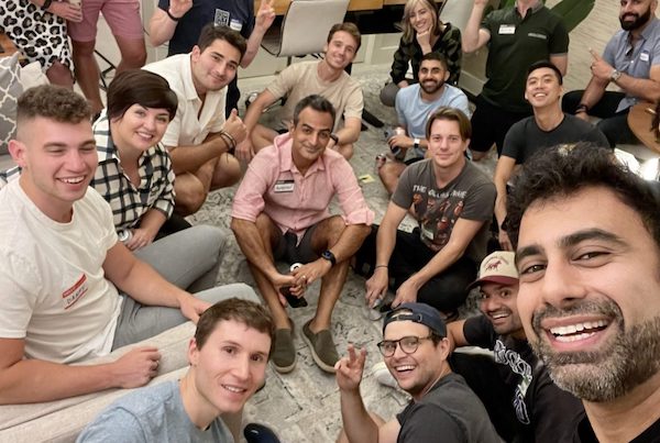 Group of people smiling and posing for a selfie with thumbs up at a Cocktail Party.