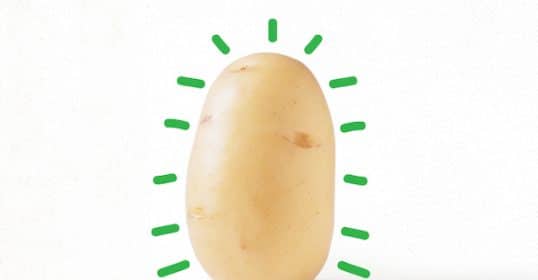 A raw potato with green lines radiating outward to suggest the health benefits or energy associated with it.