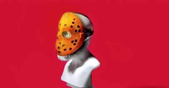 A bust statue wearing a hockey mask against a red background, embodying the wisdom discussed in Podcast #889.