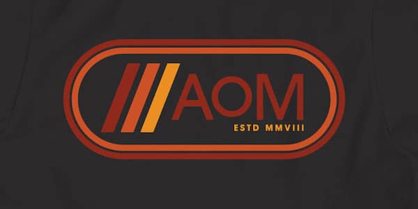 Graphic logo with stylized letters "AoM" on a dark background, indicating an establishment year of 2008 in roman numerals (MMVIII) for AoM Retro.