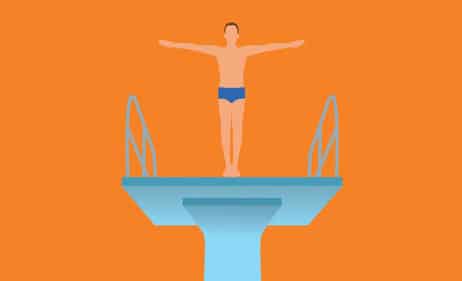 Man standing on a diving board, getting psyched up to dive.