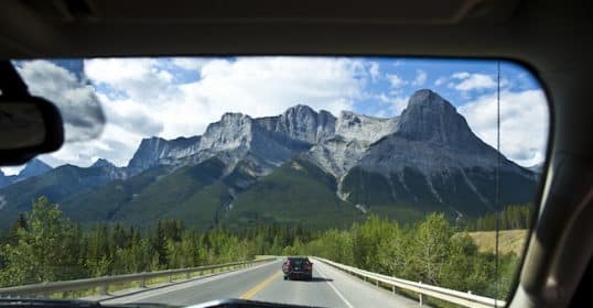 View of a mountain range from a car traveling on a highway for 8 hours.