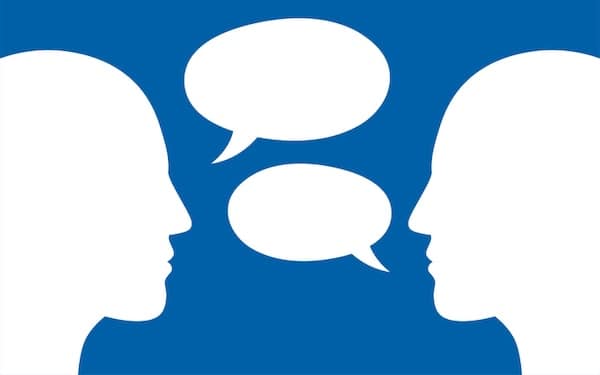 Two silhouetted profiles facing each other with speech bubbles indicating a conversation on the "Road to Character.