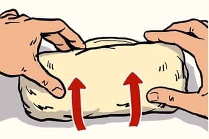 Two hands shaping dough with upward arrows indicating how to fold a burrito.