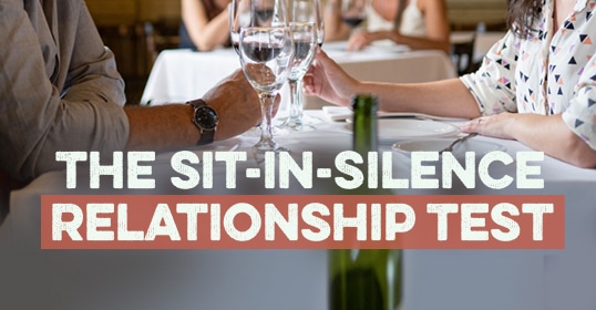 An image depicting a couple at a dining table, introducing 'the Sunday Firesides Sit-in-Silence Relationship Test' concept.