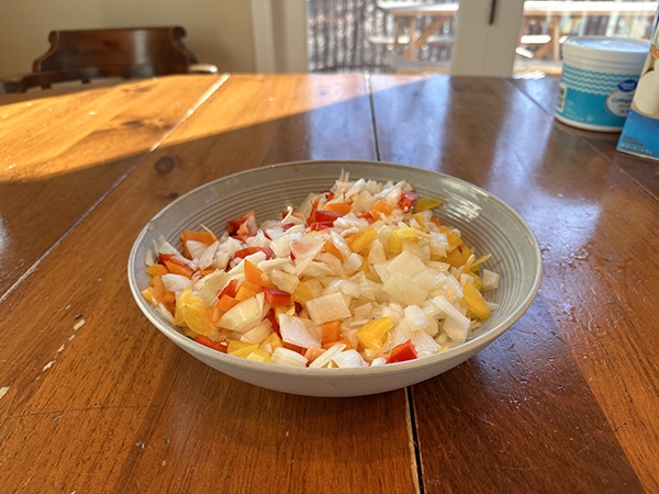 A super easy bowl of chopped vegetables on a table.