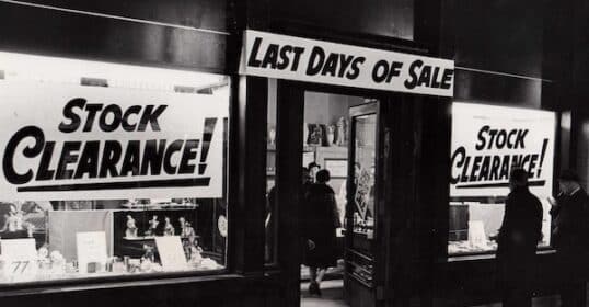 A store with large signs in the windows reading