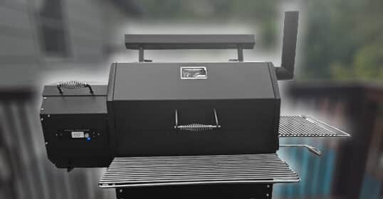 Black outdoor wood pellet smoker on a wheeled cart with side shelves.