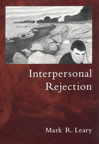 Book cover titled "Interpersonal Rejection" by Mark R. Leary, featuring a grayscale illustration of a person sitting among rocks near a body of water, capturing the solitude that often accompanies the sting of rejection and the journey to deal with such emotional hurts.