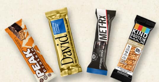 Four of the best protein bars—Peak Protein, David Protein Bar, MET-Rx, and KIND Protein—are artfully displayed against a neutral background, showcasing their appeal as top choices for protein supplements.