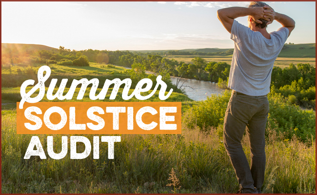 A person stands in a grassy field overlooking a river at sunset, celebrating the Summer Solstice. Text on the image reads, “Summer Solstice Audit.”.